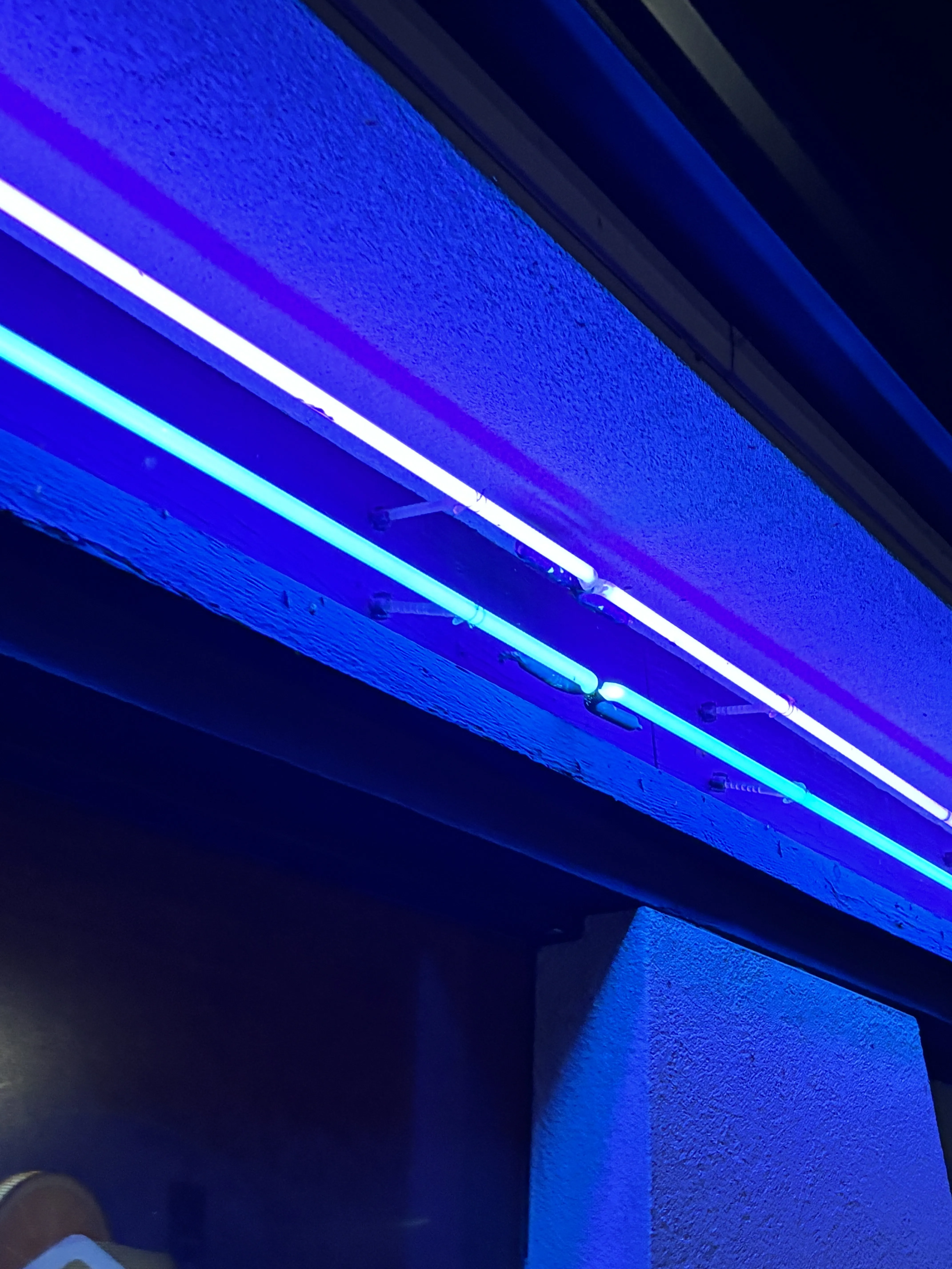 Zoomed in view of two parallel blue neon lights
