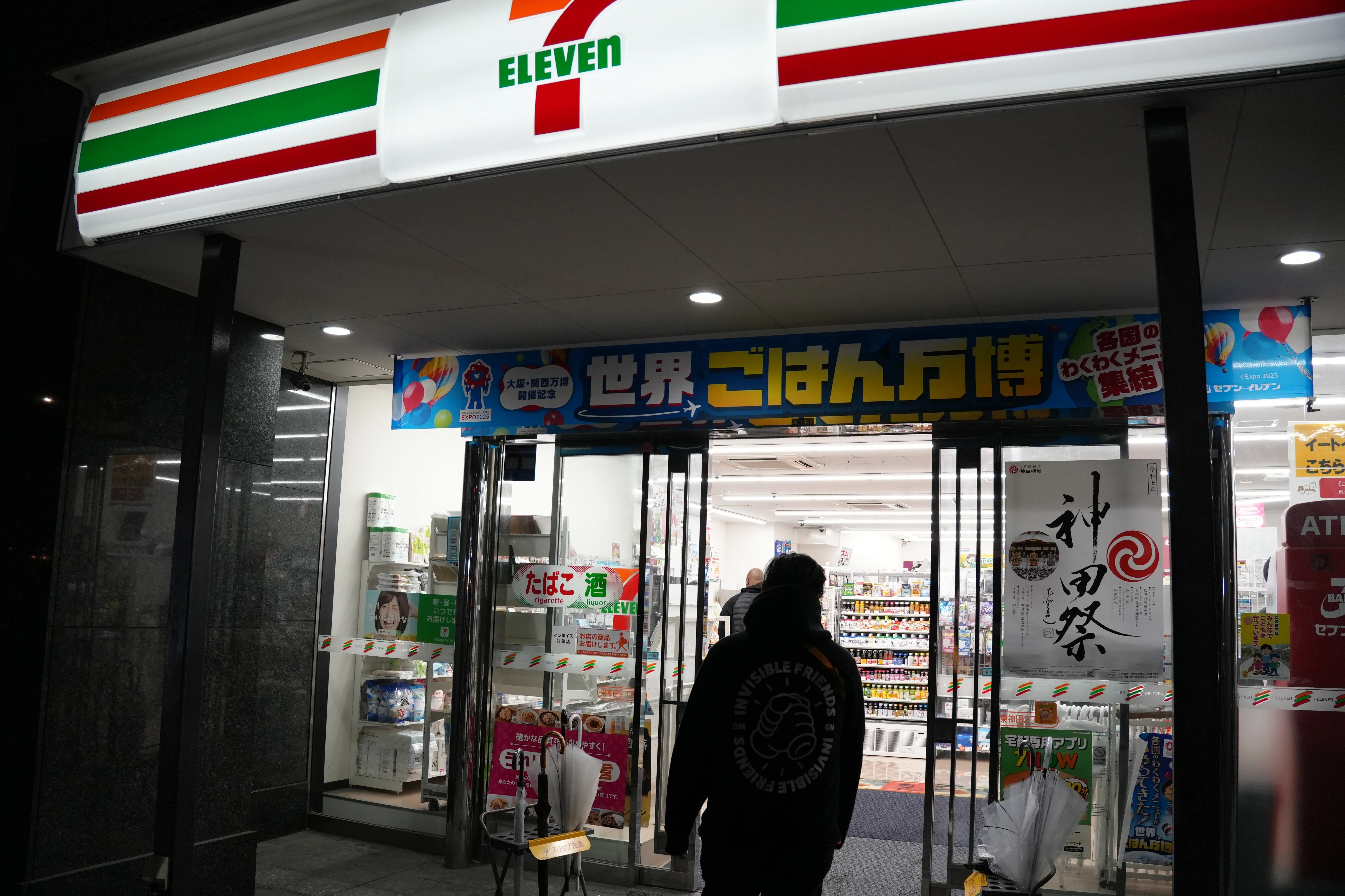 Quinn walking into a 7-11 convenience store with a hoodie that reads, 'Invisible Friends'
